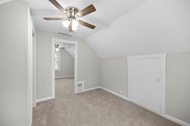 bonus room featuring a ceiling fan, carpet flooring, lofted ceiling, and baseboards