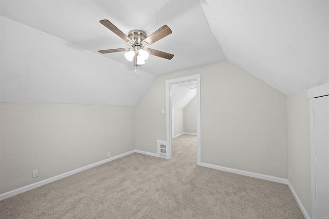 additional living space with baseboards, ceiling fan, lofted ceiling, and carpet