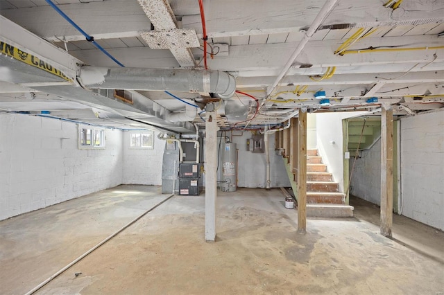 basement featuring gas water heater, heating unit, and stairs