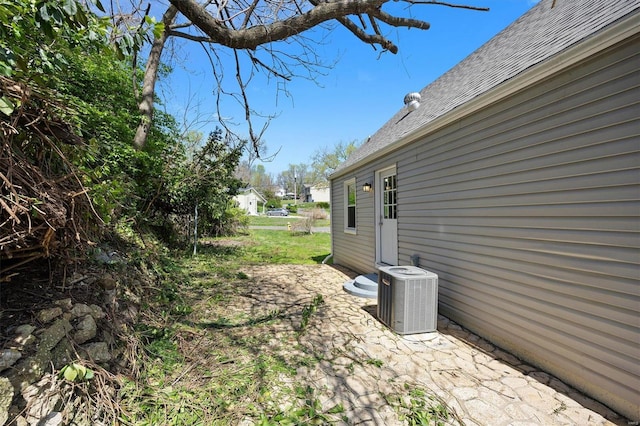 view of yard with cooling unit and a patio area