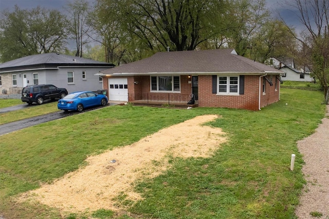 ranch-style home featuring brick siding, a garage, driveway, and a front yard