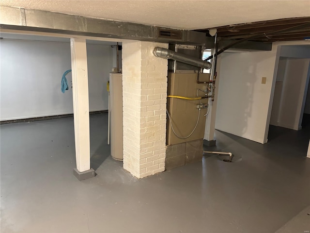unfinished basement featuring water heater, heating unit, and visible vents