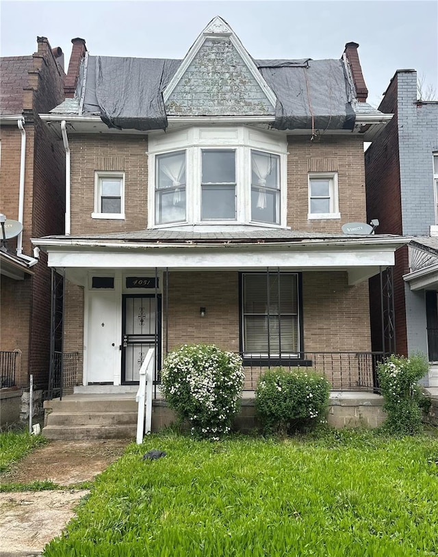 multi unit property with covered porch and brick siding