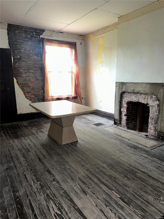 interior space featuring a fireplace with flush hearth and wood finished floors