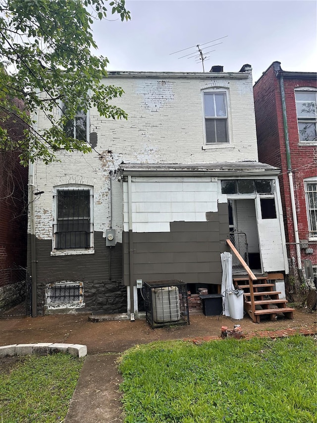 rear view of house featuring central AC