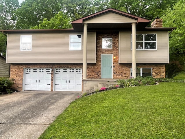 raised ranch with brick siding, an attached garage, driveway, and a front lawn
