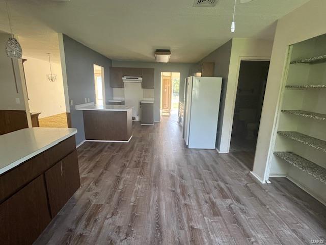 interior space featuring visible vents and dark wood-type flooring