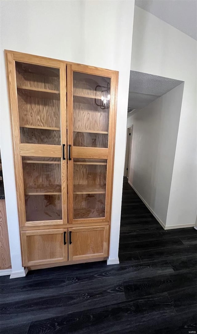 room details featuring baseboards and wood finished floors