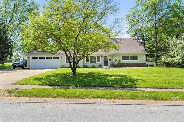 view of front facade with an attached garage, a front lawn, and concrete driveway