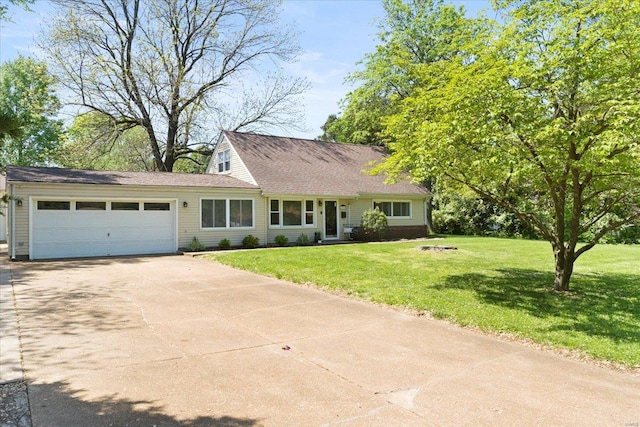 view of front of house with driveway, a front lawn, and a garage