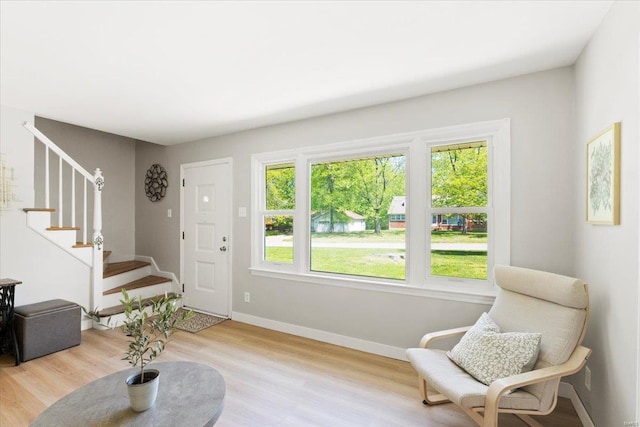 interior space with stairs, baseboards, and wood finished floors