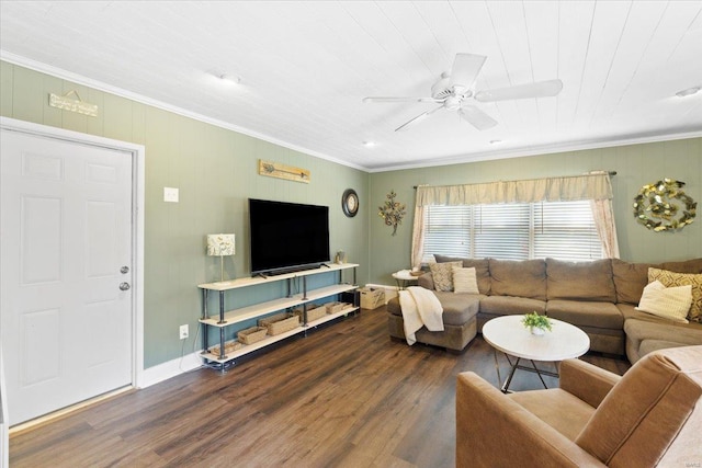 living room with baseboards, ornamental molding, a ceiling fan, and wood finished floors