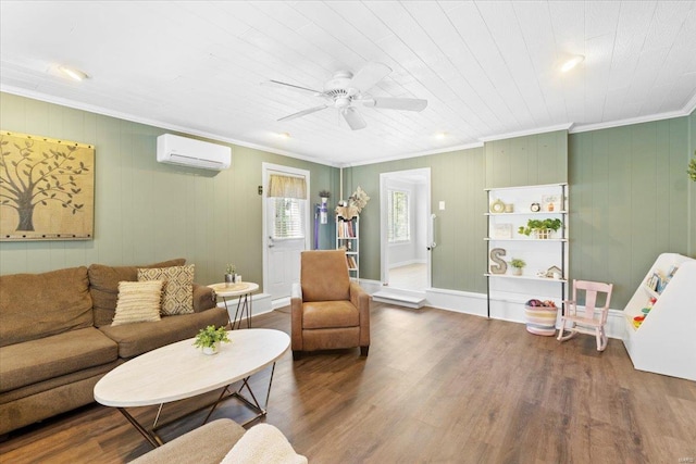 living area featuring ceiling fan, ornamental molding, a wall mounted air conditioner, and wood finished floors