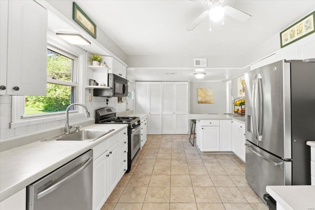 kitchen with a sink, light countertops, stainless steel appliances, and visible vents