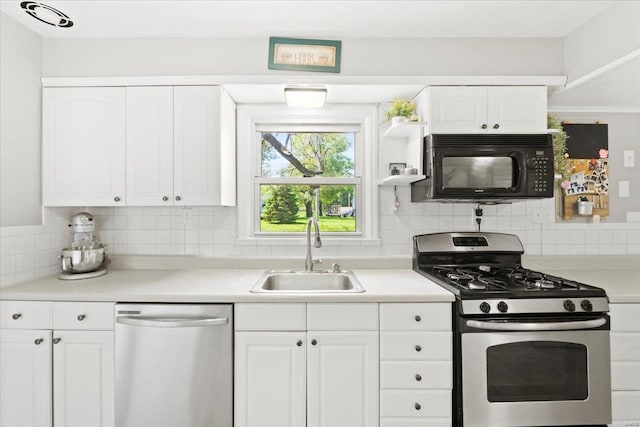 kitchen featuring light countertops, white cabinetry, tasteful backsplash, a sink, and stainless steel appliances