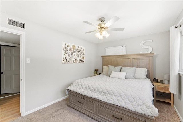 bedroom with baseboards, ceiling fan, light carpet, and visible vents