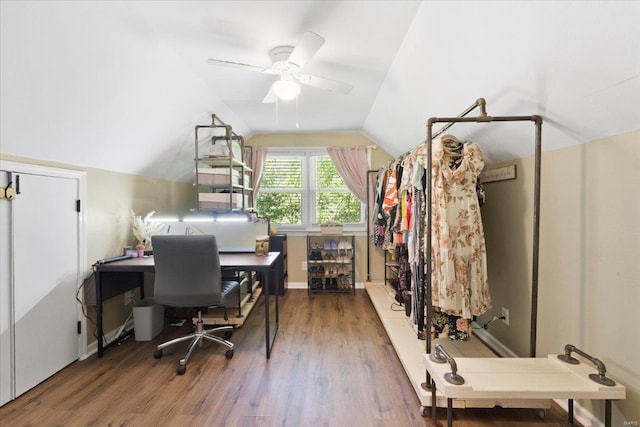 office featuring baseboards, ceiling fan, vaulted ceiling, and wood finished floors