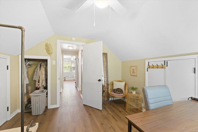 home office featuring baseboards, a ceiling fan, wood finished floors, and lofted ceiling