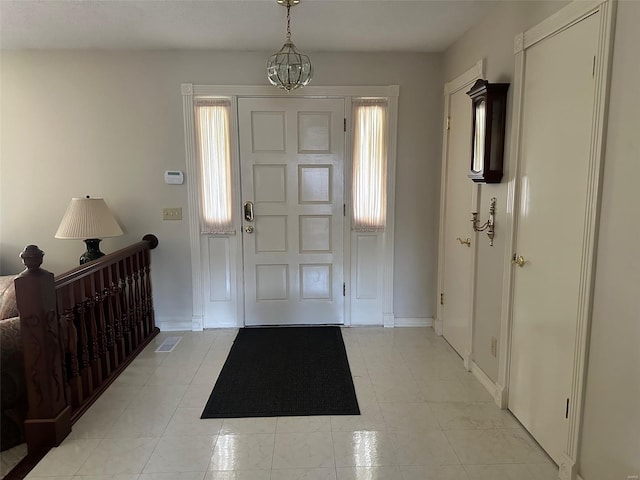 foyer with baseboards and a wealth of natural light