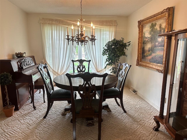 carpeted dining area featuring baseboards, a chandelier, and visible vents