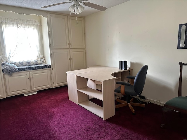 office area with ceiling fan, dark carpet, and visible vents