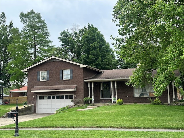 split level home with concrete driveway, brick siding, a front lawn, and a garage