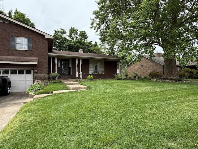 split level home featuring a garage, a front lawn, a chimney, brick siding, and concrete driveway