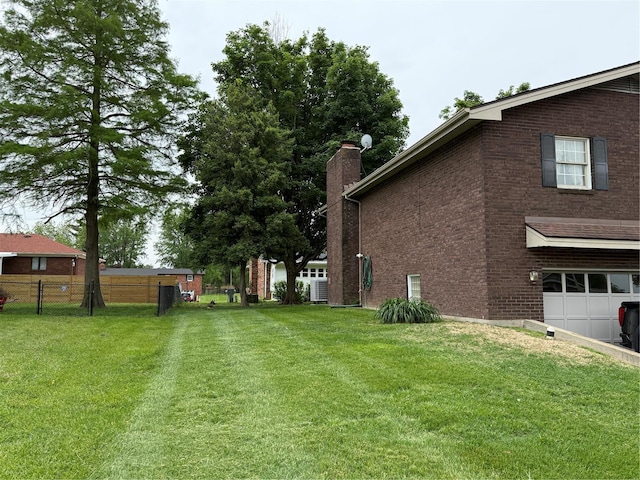 view of yard with a garage and fence