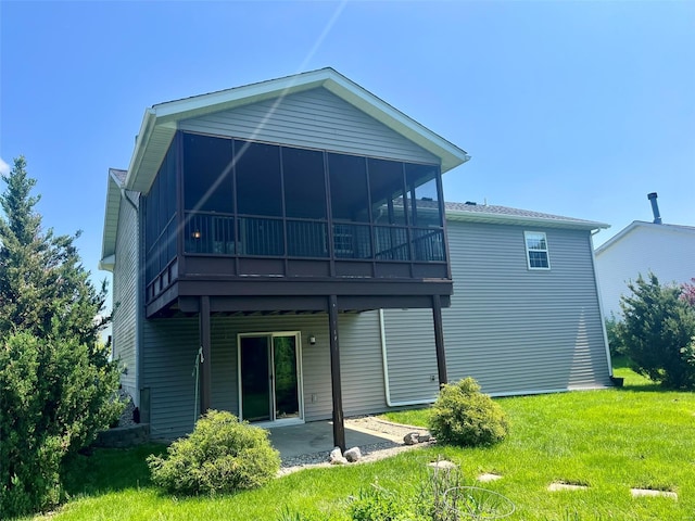 back of property featuring a lawn, a patio, and a sunroom