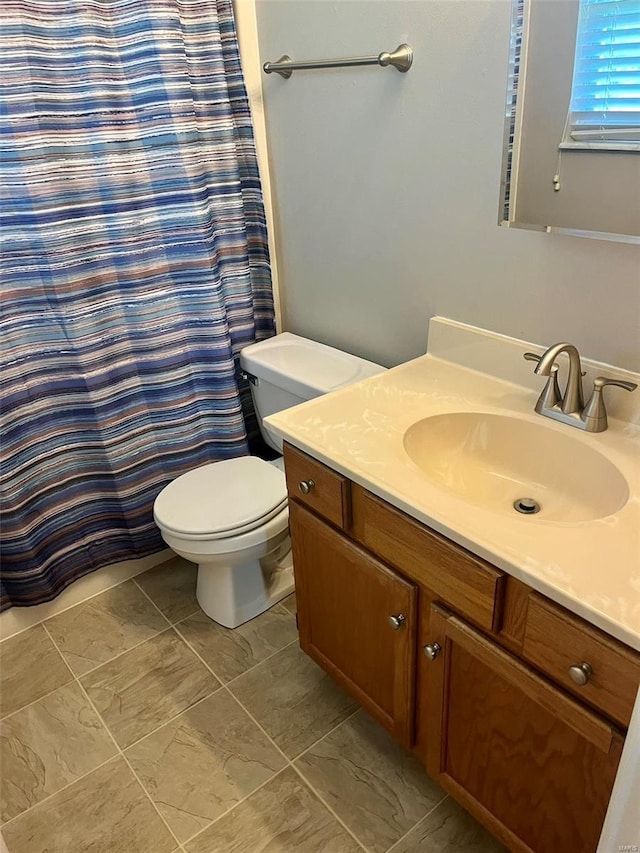 full bath featuring vanity and toilet