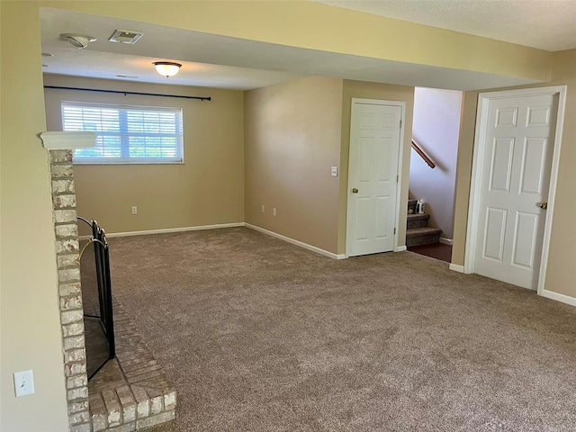 unfurnished living room featuring stairway, visible vents, baseboards, and carpet