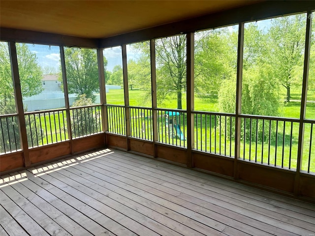 unfurnished sunroom featuring a deck and hardwood / wood-style floors