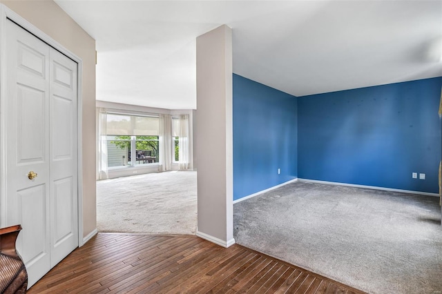 bonus room with carpet floors, baseboards, and hardwood / wood-style floors