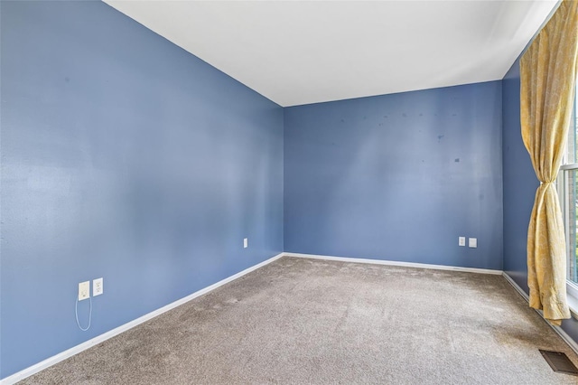 carpeted empty room with baseboards and visible vents