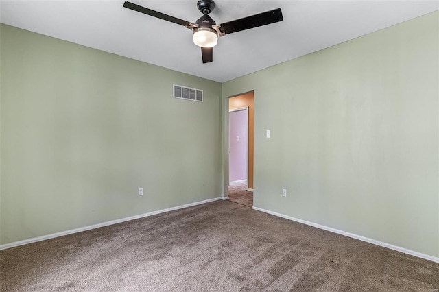 empty room with visible vents, a ceiling fan, baseboards, and carpet flooring
