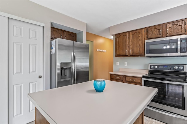kitchen featuring light countertops, appliances with stainless steel finishes, and a kitchen island