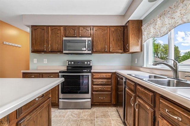kitchen with light countertops, stainless steel appliances, and a sink