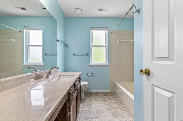 bathroom with visible vents, a healthy amount of sunlight, and toilet