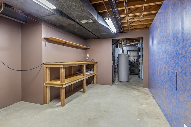unfinished basement featuring visible vents and gas water heater