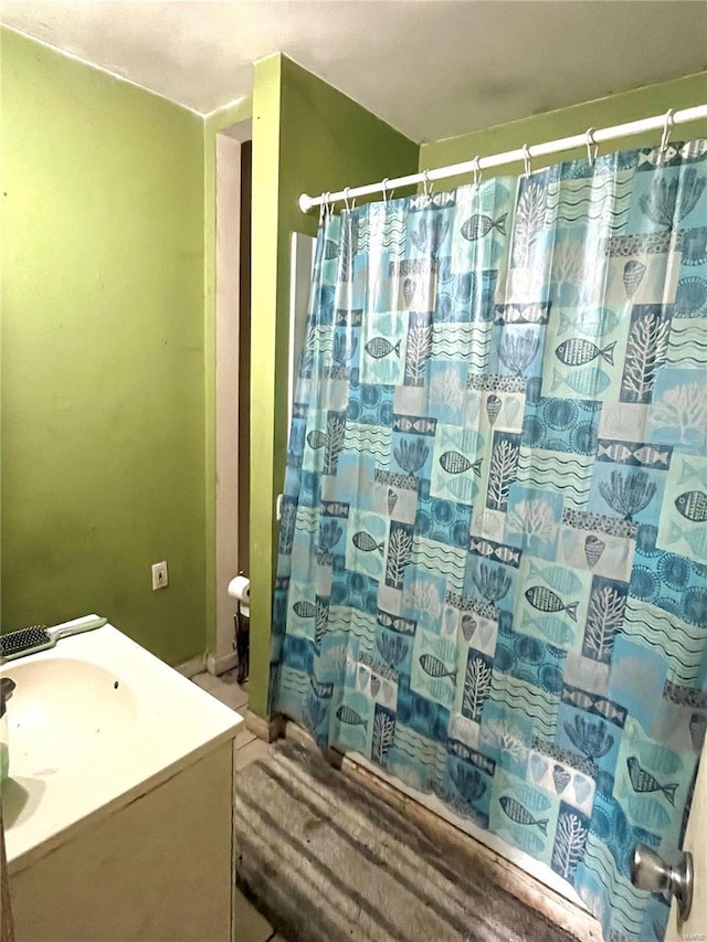 full bath with a sink and a shower with shower curtain