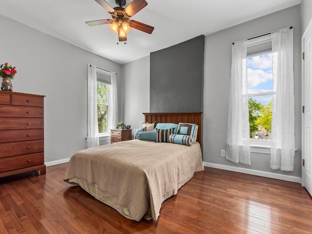 bedroom with baseboards, ceiling fan, and hardwood / wood-style floors