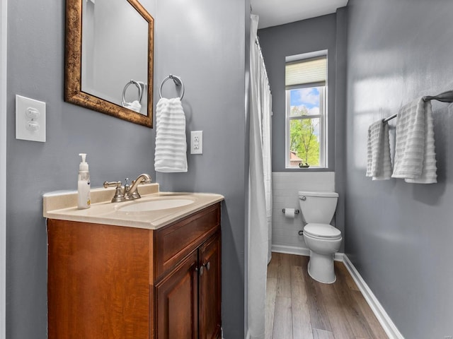 full bathroom with toilet, wood finished floors, and vanity