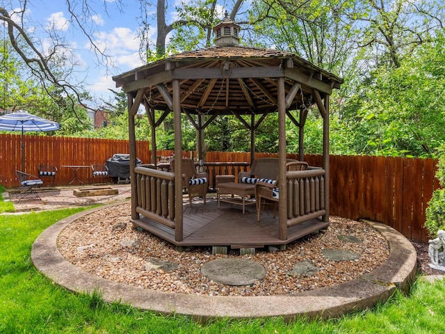 view of patio / terrace featuring a gazebo, a wooden deck, and fence private yard