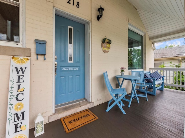 view of exterior entry with a porch