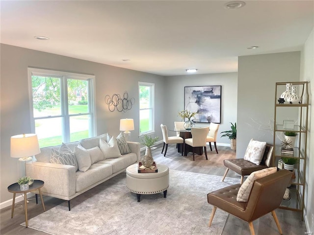 living room with baseboards, recessed lighting, and wood finished floors