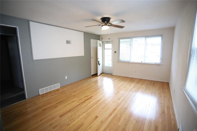 unfurnished room with visible vents, a ceiling fan, and a healthy amount of sunlight