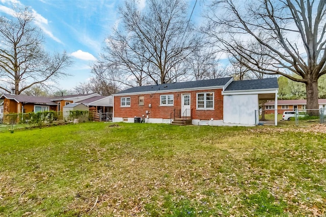back of property with brick siding, entry steps, a gate, a fenced backyard, and a yard