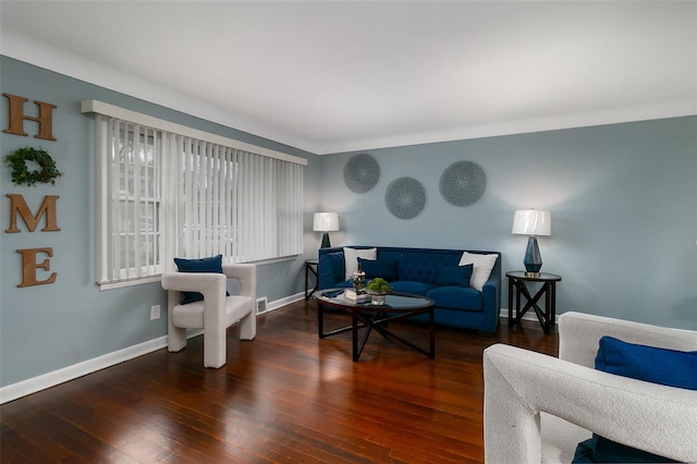 living area featuring baseboards and wood finished floors