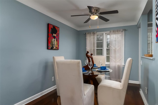 dining room with baseboards, ceiling fan, and wood finished floors