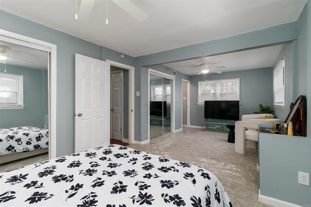 bedroom featuring baseboards, visible vents, multiple windows, and ceiling fan